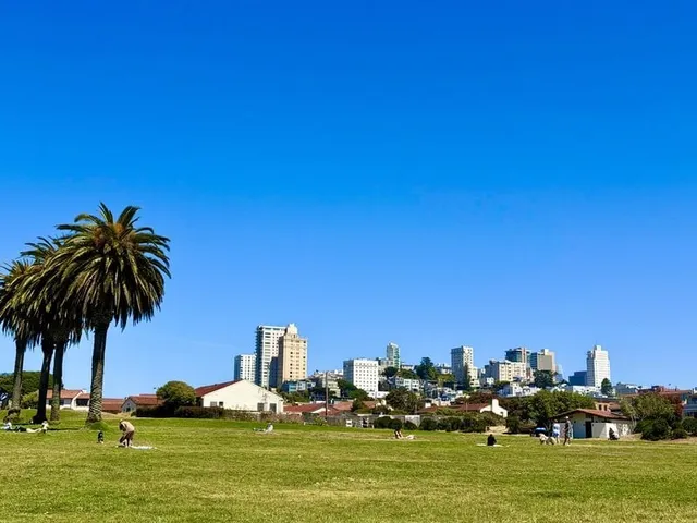 Fort Mason's Great Meadow with palm trees and the Russian Hill skyline