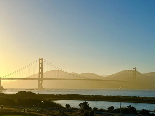 The Golden Gate Bridge at golden hour, seen from Crissy Field